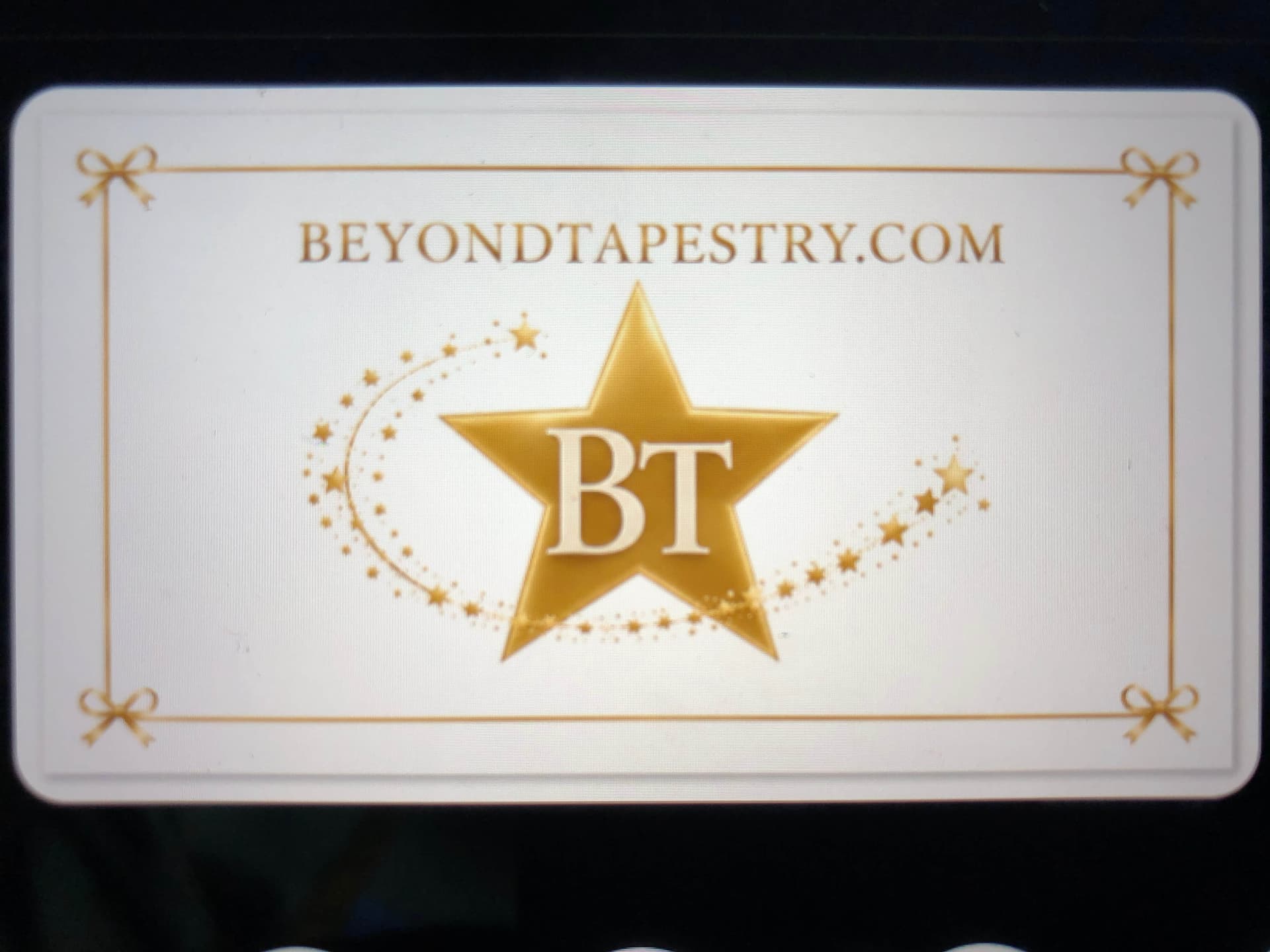 Beyond Tapestry gold star BT brand card on white background